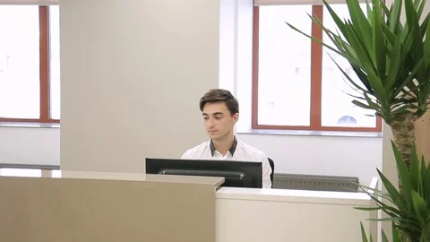 Woman asks man at reception to send important documents for management. Stock Footage 82235768