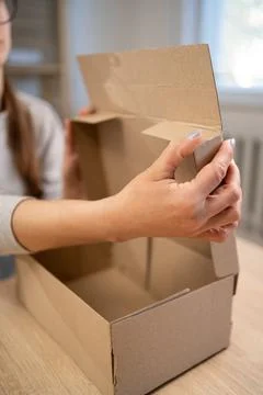 Woman assembling boxes for start-up. Cardboard box. Self-assembly. Stock Photos