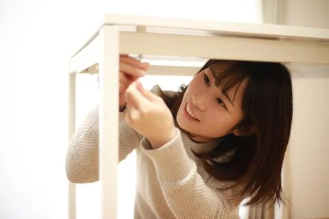 Woman assembling a table Stock Photos