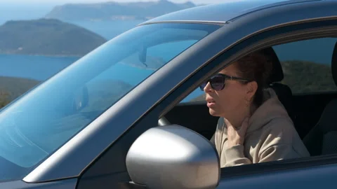 Woman with asthma attack using an inhaler while driving a car. Stock Footage 333213050
