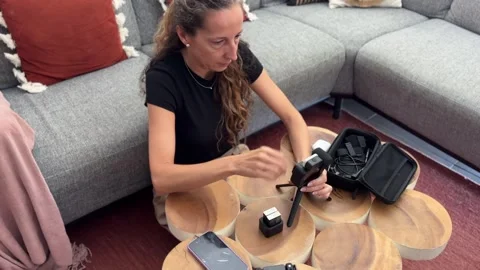 Woman attaching light to camera for content creation Stock Footage 342498273