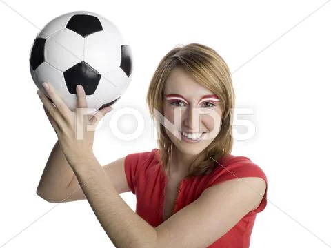 Woman with austrian flag painted on eyebrows holding football Stock Photos