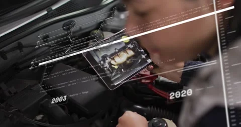 Woman auto tech leaning over engine holding tablet initiating check as years Stock Footage 329910417