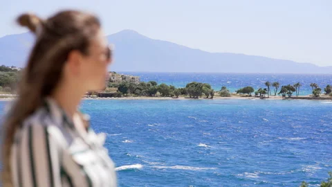 Woman on a background of sea waves and a beautiful mountain landscape. Stock Footage 157446460