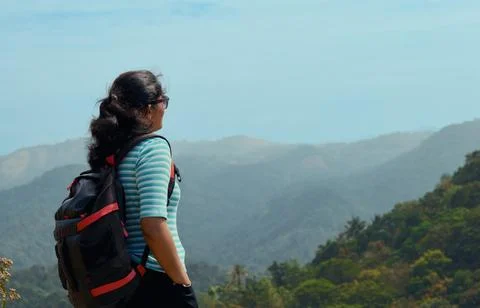 Woman with Backpack Admiring Mountain View Stock Photos