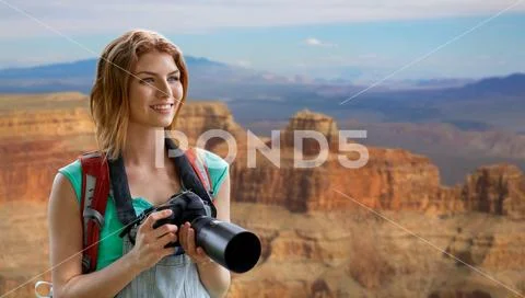 Woman with backpack and camera at grand canyon Stock Photos