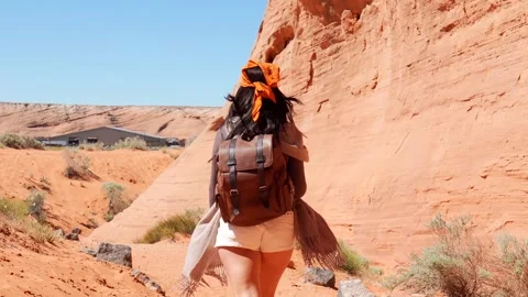 Woman with backpack exploring the biidi arch cave Stock Footage 334853032