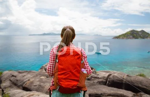 Woman with backpack over seychelles island Stock Photos