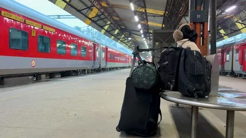 Woman with backpack sitting at station platform waiting for train Video stock 329111231