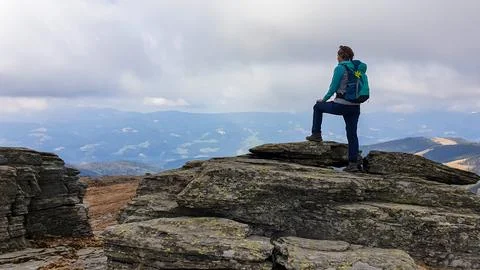 Woman with backpack standing on massive rock formation at Steinerne Hochzei.. Stock Photos