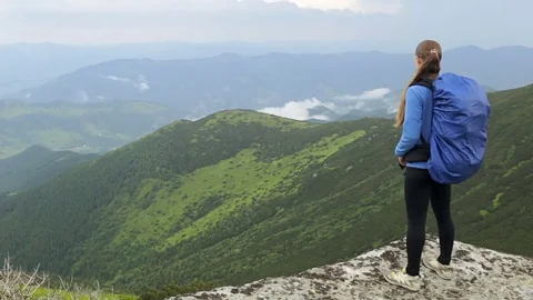 Woman with backpack standing on mountain Stock Footage 75203887