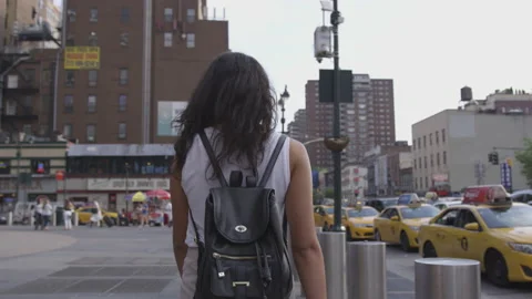 Woman with a Backpack Walking Down the Streets of New York Video stock 208728624