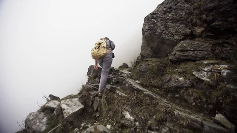 Woman with backpack walking on mountain path Stock Footage 97861291