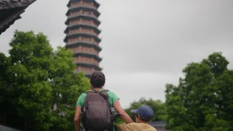 Woman with backpack walking through Southeast Asian temple Stock Footage 248513891