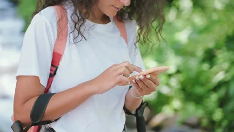 Woman backpacker using smartphone with electronic map for navigation in route in Stock Footage 241239064