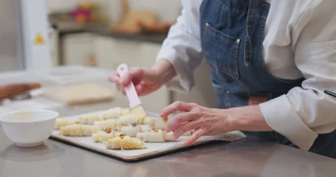 Woman baker preparing raw dough for pastry on baking manufacture Stock Footage 237908367