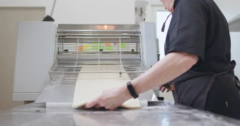 Woman baker preparing raw dough for pastry on baking manufacture Stock Footage 237953053