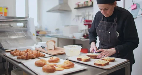 Woman baker preparing raw dough for pastry on baking manufacture Stock Footage 237967906