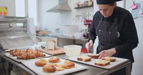 Woman baker preparing raw dough for pastry on baking manufacture Stock Footage 237967913