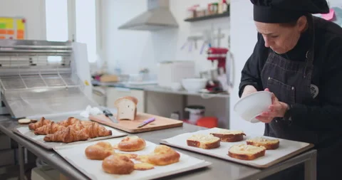 Woman baker preparing raw dough for pastry on baking manufacture Stock Footage 237967968
