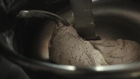 Woman baker uses scraper to separate and remove piece of cooked dough from bowl Stock Footage 339864893