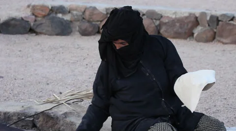 A woman bakes bread on the fire, in a Beduin Camp near Mount Sinai, Egypt Stock Footage 39221444