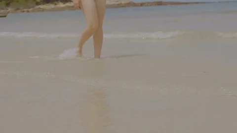 Woman bare feet walking on the summer beach. close up leg of young woman walking Stock Footage