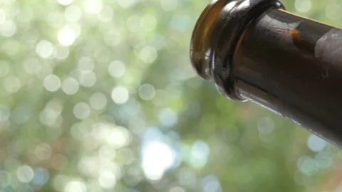 Woman Bartender Pops Open a Bottle of Champagne at an Outdoor Bar Stock Footage 76205810