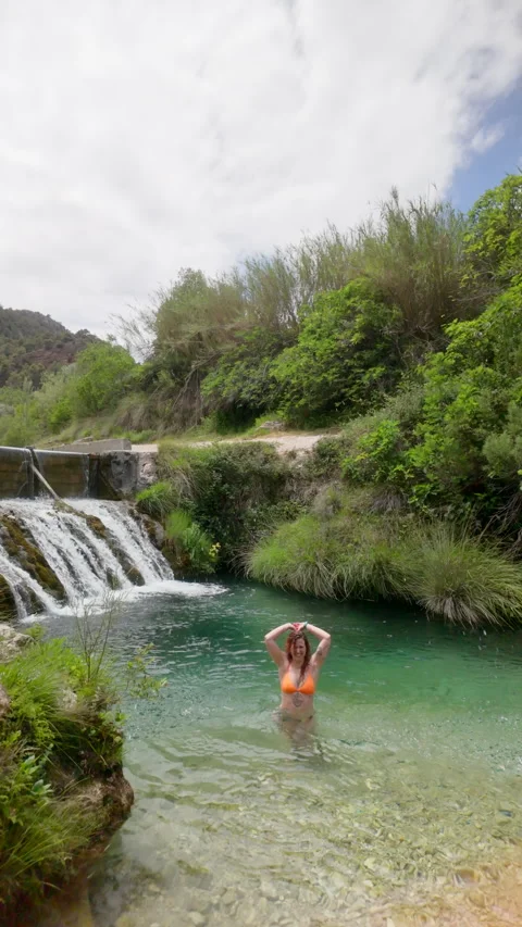 A woman is bathing in a stream Stock Footage 277410030