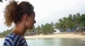 Woman in Beach Cafe Drinking Water. Seashore with Palms. Tropical Rainy Day. HD Footage