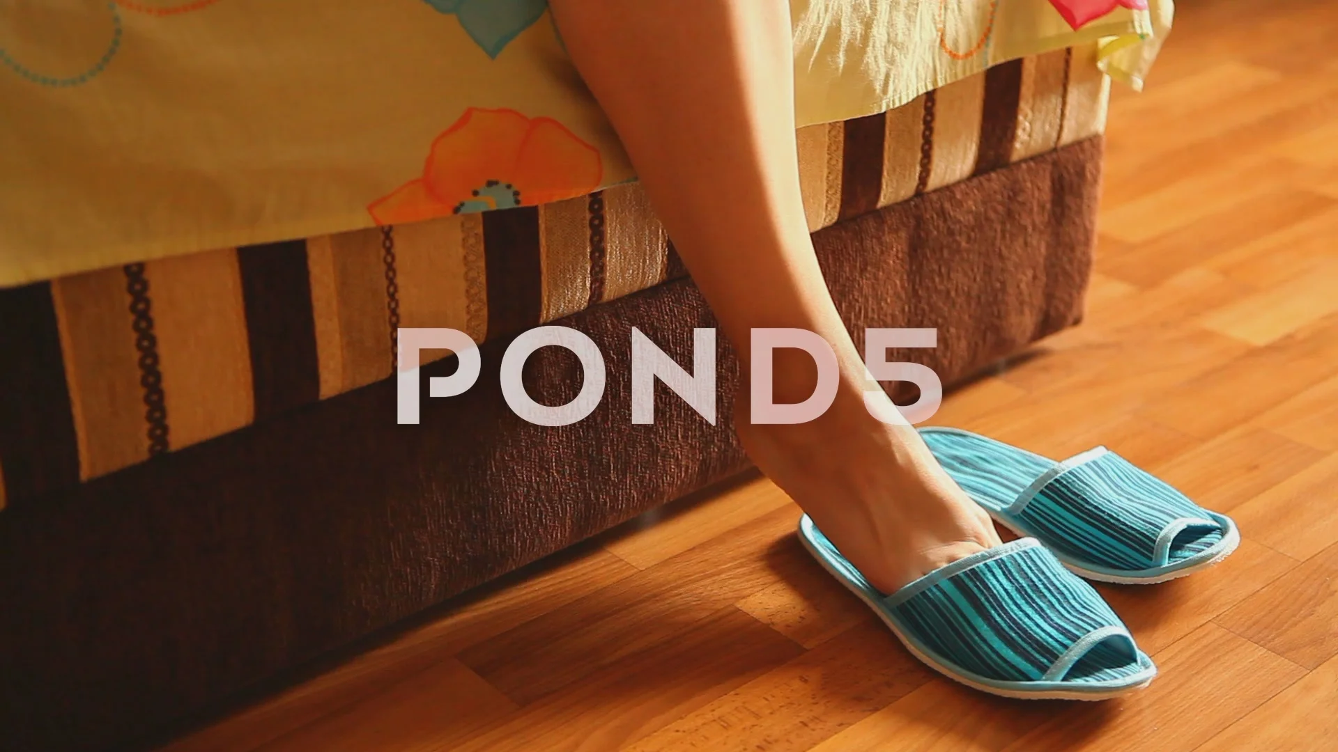 Woman beautiful legs with slippers in the morning as a wake up concept