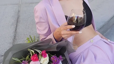 Woman with beautiful smile is standing in doorway of balcony with a glass of Stock Footage