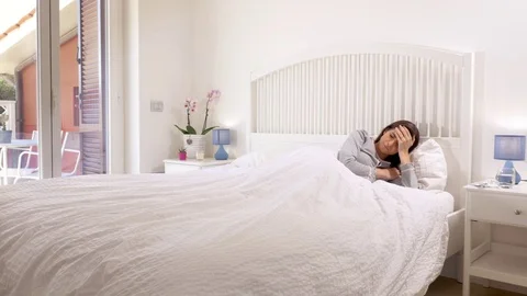 Woman in bed measuring temperature feeling ill Stock Footage 74942886