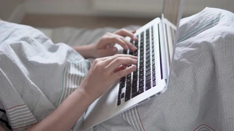 Woman In Bed Typing On Keyboard, Using Laptop, Distance Working From Home Stock Footage