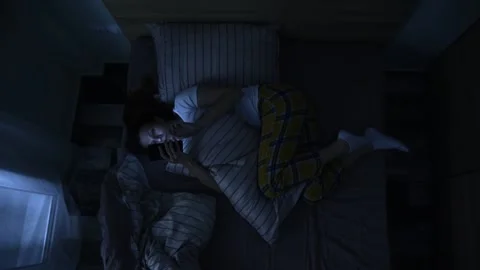 Woman in bed using smartphone at night. Stock Footage 147122271