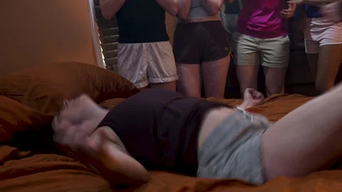 Woman on bed writhes during a exorcism Stock Footage 313684853