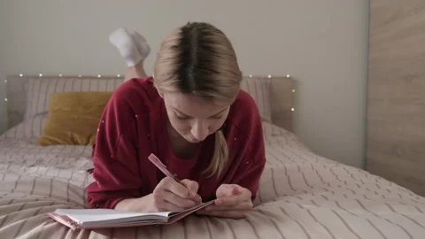 Woman in bed writing in diary. Stock Footage 170239111