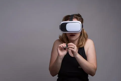 Woman being afraid while experiencing virtual reality using a VR gadget 스톡 사진