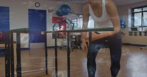 Woman bending down checking bars in rehab using phone showing alignment lines Stock Footage 334312597