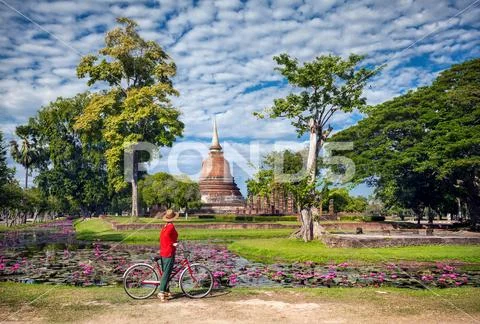 Woman with bicycle near temple in Thailand Stock Photos