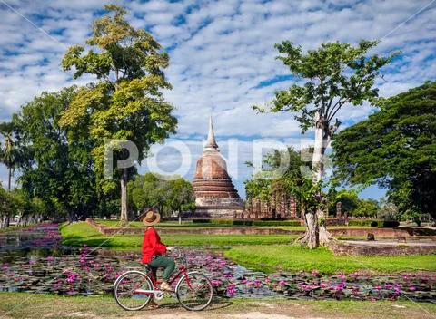 Woman with bicycle near temple in Thailand Stock Photos
