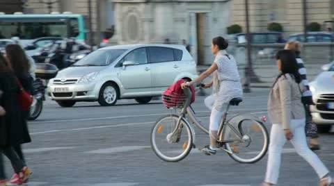 Woman on bike in Paris Stock Footage