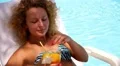 Woman in Bikini on Chaise Longue Drinking Fresh Juice by the Pool. HD Footage