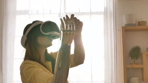 Woman with bionic arm uses virtual reality headset to dance Stock Footage 150239973