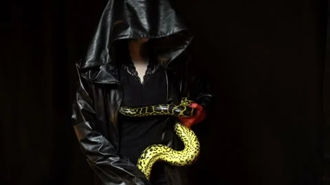 Woman in black coat with python Stock Footage 94682043