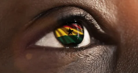 Woman black eye in close up with the flag Ghana in iris with wind motion. video Stock Footage
