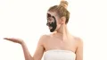 The woman with a black face care mask gesturing on the white background 4k or 4k+ Resolution