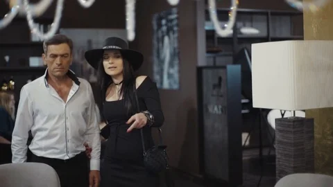 A woman in a black hat and man go to the office. Shows workplace. Office Stock Footage