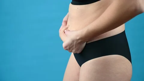 Woman in Black Underwear Holds Her Belly Fat. Thick Folds on