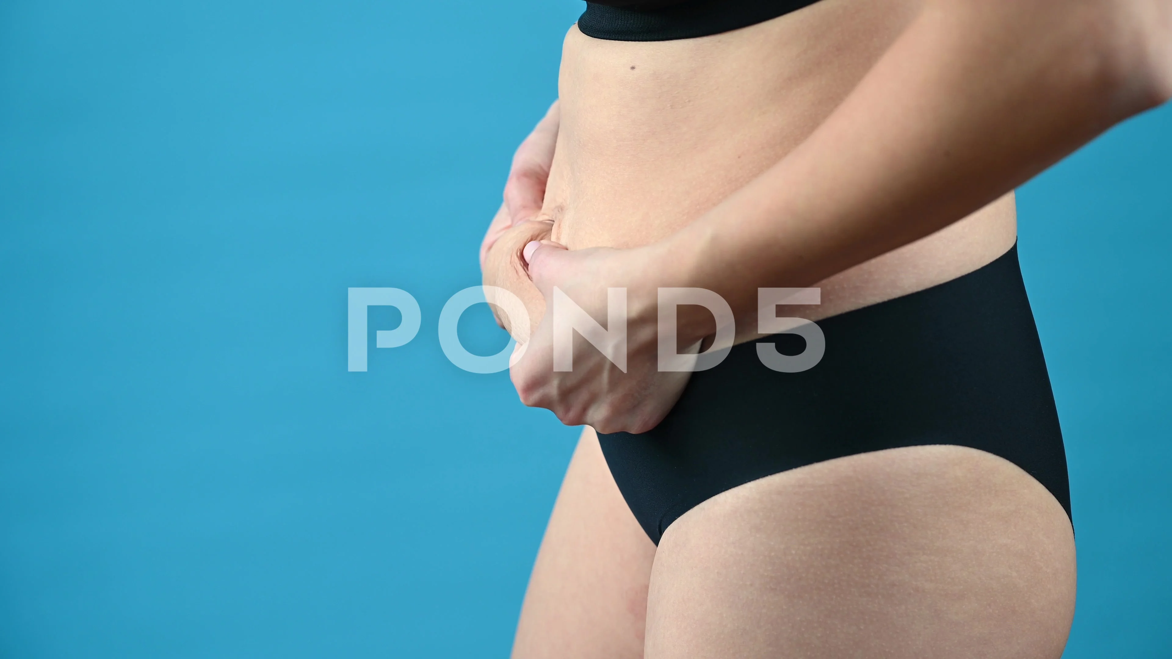 The Woman in Underwear Holds Belly Fat. Closeup., People Stock